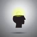 Light bulb in brain and head on gray background