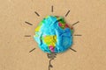 Light bulb drawing and planet earth on crumpled recycled paper - Concept of ecology and green energy innovation Royalty Free Stock Photo