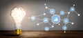 Light bulb with gears and icons representing innovation, technology, and data analysis connected through a network in a Royalty Free Stock Photo