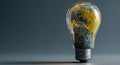 A light bulb globe displays glowing green continents over a dark gradient background Royalty Free Stock Photo