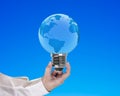 Light bulb of globe shape with man's hand holding Royalty Free Stock Photo