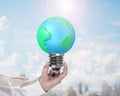 Light bulb of globe shape with man's hand holding Royalty Free Stock Photo