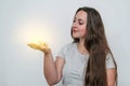 Light bulb glowing in the hand of a dark-haired cute woman. Energy conservation. New technologies Royalty Free Stock Photo