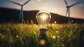 A light bulb green field wind turbine Royalty Free Stock Photo