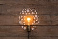 Retro light bulb and group of gears on wooden background - idea, innovation, teamwork and leadership concept. Space for text