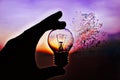 Light bulb in hand at sunset, the effect of decay Royalty Free Stock Photo