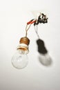 Light bulb hanging from bare wires