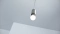 Light bulb hanging from ceiling, energy saving and energy efficiency, service Royalty Free Stock Photo