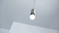 Light bulb hanging from ceiling, energy saving and energy efficiency, service Royalty Free Stock Photo