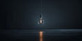 A light bulb hanging from a string in a dark room Royalty Free Stock Photo