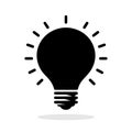Light bulb icon. Black silhouette of a light bulb with rays on white background Royalty Free Stock Photo