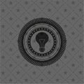 Light bulb icon inside black emblem. Vintage Royalty Free Stock Photo