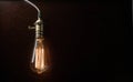 The light bulb illuminates on wooden background Royalty Free Stock Photo