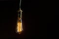 The light bulb illuminates on wooden background Royalty Free Stock Photo