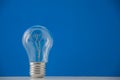A light bulb inside which there are two hearts on classic blue background. Copyspace for text Royalty Free Stock Photo