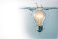 The light bulb is lit underwater with air bubbles. Space for text. Royalty Free Stock Photo