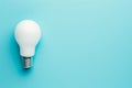 Light bulb is lit up on a blue background Royalty Free Stock Photo