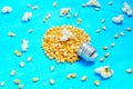 Light bulb made from pop corn kernels on blue Royalty Free Stock Photo