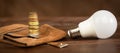 Light bulb with money coins, saving energy, save power banner Royalty Free Stock Photo