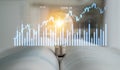 Light Bulb on Open Book with Financial Charts and Data Visualizations Representing Investment, Business Strategy, and Royalty Free Stock Photo