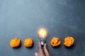 Hand holding light bulb put in the middle of orange papers it for idea,energy,solar concept. Royalty Free Stock Photo