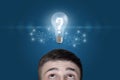 Light bulb with a question mark above the man head Royalty Free Stock Photo