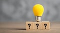 Light bulb question mark idea creativity innovation problem solving concept yellow wooden block solution Light bulb above wooden Royalty Free Stock Photo