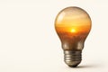 A light bulb with a reflection of the sunset inside. Space for text. Royalty Free Stock Photo