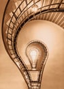 Light bulb in the shape of a cubist staircase in a historical building of Prague colored in historic brown colors.