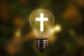 Light bulb with shining cross symbol Royalty Free Stock Photo