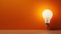 A light bulb sitting on a wooden table in front of an orange wall, AI Royalty Free Stock Photo