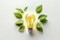 Green Leaves Surrounding Light Bulb on White Surface