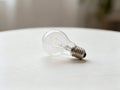 Light Bulb on Table Close Up - AI generated Royalty Free Stock Photo