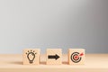 light bulb and target icon on wooden cube Royalty Free Stock Photo