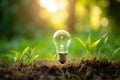 Light bulb and tree growing on the ground on bokeh nature background, Idea of renewable energy and energy saving Royalty Free Stock Photo