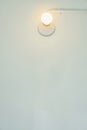 Light bulb on white wall. Fits into the background or the wallpapers.