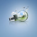 Light bulb with windmill and forest inside, Ecological idea