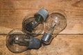 Light bulb on a wooden background. old glass lamp lies on the table Royalty Free Stock Photo