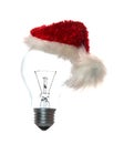 Light bulb with xmas cap Royalty Free Stock Photo