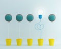 Light bulbs balloon glowing one different idea Cactus balloon other in yellow flower pot on pastel blue background,minimal conce