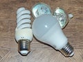 Light bulbs with different light and electrical characteristics on a wooden table. Royalty Free Stock Photo