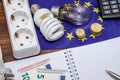 Light Bulbs on european banknotes with empty notepad and pen, calculator Royalty Free Stock Photo