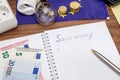 Light Bulbs on european banknotes with empty notepad and pen Royalty Free Stock Photo