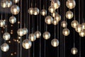 Light bulbs hanging from the ceiling, lamps on the dark background, selective focus, horizontal