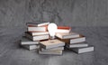 Light bulbs on stack of books. Concept of reading books, knowledge, and search for new ideas.