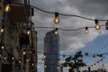 light bulbs on string wire hanging on poles against sunset sky Royalty Free Stock Photo