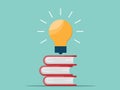 Light bulg floating on stack of books Royalty Free Stock Photo