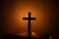 Light candle with holy bible and cross or crucifix on old wooden background in church.Candlelight and open book on vintage wood Royalty Free Stock Photo