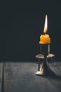 Light candle with holy bible and cross or crucifix on old wooden background in church.Candlelight and open book on vintage wood Royalty Free Stock Photo