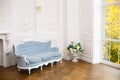 Light classic royal interior with blue soft sofa with fabric upholstery
